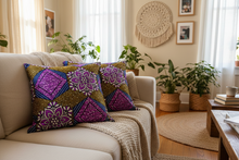 Decorative pillows on a beige sofa in a living room with plants and a coffee table.