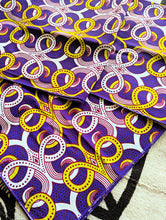 Colorful purple fabric with geometric pattern on a textured surface