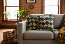 purple green african print pillows styled on sofa