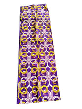 Purple headwrap with yellow and white circular pattern on a white background