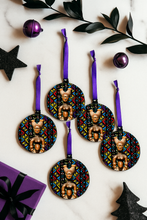 Decorative Christmas ornaments with geometric African patterns on a white background with purple and black accents.