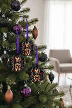 Decorative Christmas ornaments with African geometric patterns on a Christmas tree.