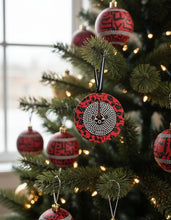 African pattern Christmas ornament on a decorated tree.