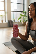 Woman holding tumbler at a yoga class 