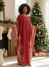 Woman wearing Red kaftan dress in Christmas setting 