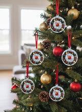 Decorative Christmas ornaments on a tree with red ribbons