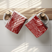 set of 2 red_white_cowrie African pattern coffee mugs hung up 