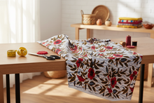 red floral african fabric on a cutting table