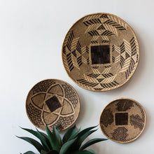 Three woven baskets with geometric patterns on a white background