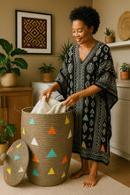 Woman in a patterned dress sorting laundry in a colorful woven basket in a home setting.