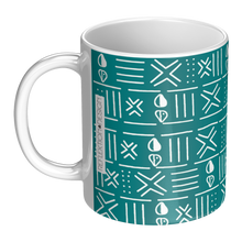 left handle view of ceramic coffee mug with teal blue and white African pattern