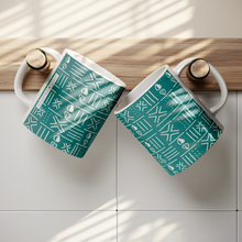 Two teal blue african pattern coffee mugs hung on on hooks