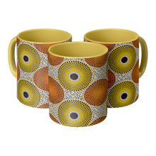 3 yellow orange african pattern coffee mugs side by side
