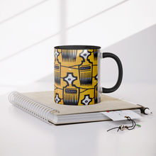 yellow black african pattern coffee mug on a book