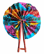 Colorful hand fan with tropical leaf pattern on a white background