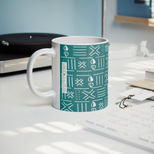 turquoise blue African pattern coffee mug on table next to record player