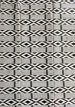 black what geometric pattern african fabric on a cutting table