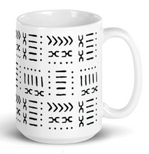 tall white ceramic coffee mug with black African design
