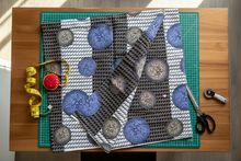 Textile with circular patterns on a cutting mat with sewing tools