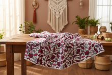 pink floral african fabric on a cutting table