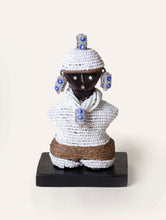 Decorative figure with white beadwork on a white background