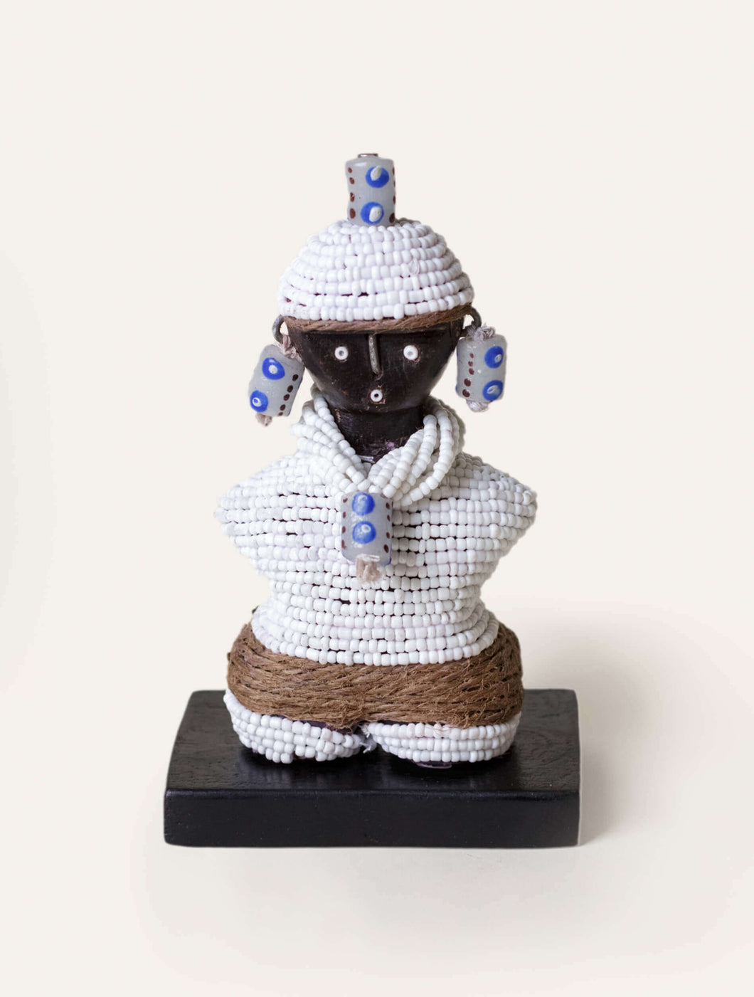 Decorative figure with white beadwork on a white background