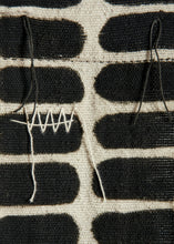 Close-up of a woven fabric with black and white pattern