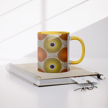 yellow orange african pattern coffee mug on book