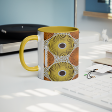 yellow orange african design coffee mug on desk