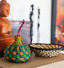 handmade woven ornament on bookshelf