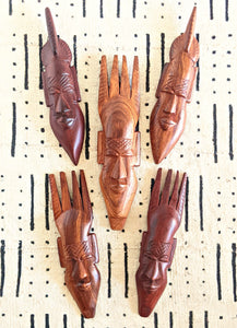 brown wood african masks male faces masculine