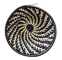 A small black and white woven African basket with a geometric pattern.